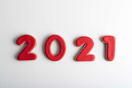 Inscription in red numbers 2021 from gingerbreadon white background. Happy New Year 2021.の写真素材