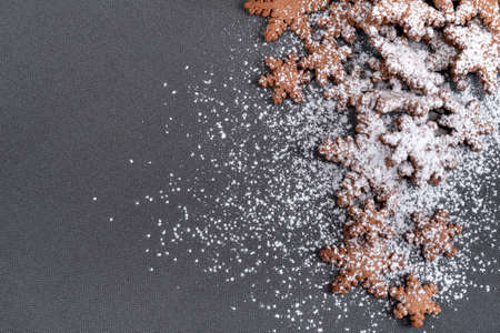 Gingerbread cookies in snowflakes shape sprinkled with powdered sugar. Copy space.の写真素材