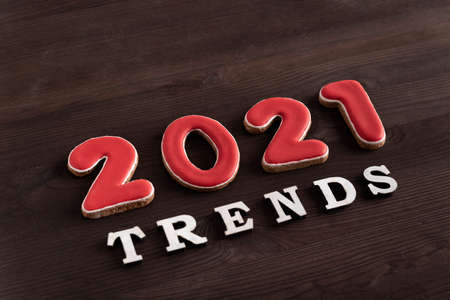 Trends 2021 lettering on dark wooden background. Trending directions in 2021.の写真素材