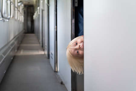 Blond boy in railroad car. Rules for traveling with children on the train.の写真素材