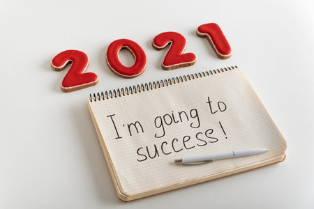 Numbers 2021 and notebook with the words Im going to success. Motivation. Goals for 2021