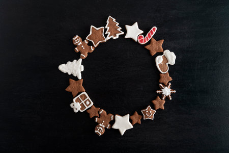 Gingerbread cookies in the shape of a circle on a black background. Copy spaceの写真素材