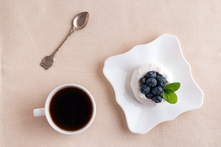 Flat lay breakfast. Cup of coffee, berry cake and spoon. Top view.の写真素材