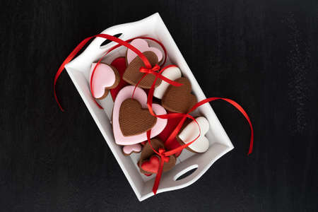 Gingerbread heart cookies top view on black background. Mothers day. Womans day. Valentines day.の写真素材