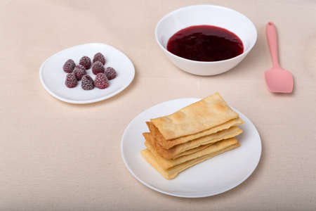 Cakes, berries and fruit jam on saucers. Ingredients for making fruit pie