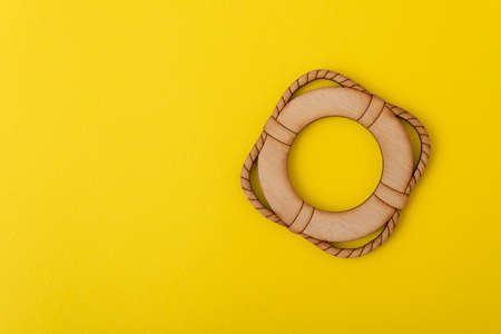 Toy lifebuoy on yellow background. safety concept.の写真素材