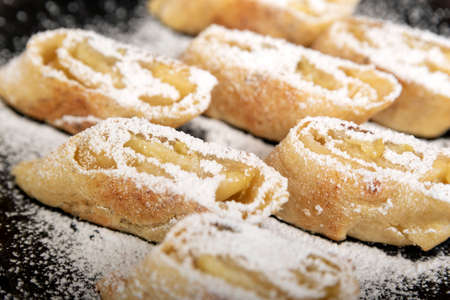 Apple roll with powdered sugar. Close up.の写真素材