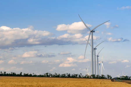 Windmills on a background of cloudy sky. Wind energy. Alternative energy