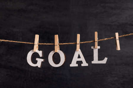 Word GOAL with clothespins on black background. Purpose.の写真素材
