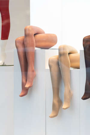Mannequins legs in shop window. Tights. Hosiery shop. Vertical frame.の写真素材
