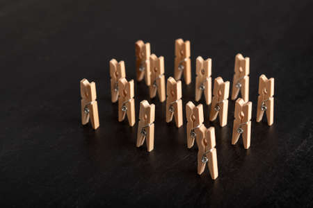 Set of wooden clothespins stand on black background. People group meeting conceptの写真素材