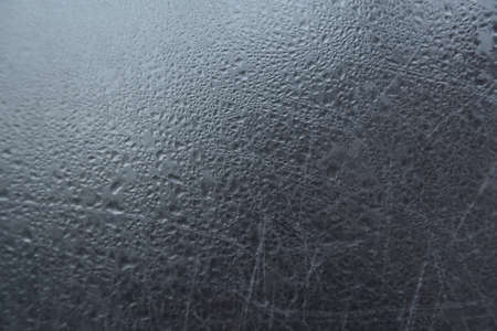 Glass with water drops. Abstract gray background with drops and stainsの写真素材