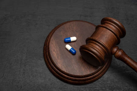 Judge gavel and pills. Litigation Medicine-Related Healthcare in Pharmaceuticals. Law in medicineの写真素材