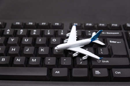 Airplane model on the keyboard. Online booking of air tickets. Buying tickets.の写真素材