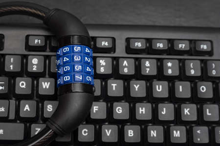 Combination lock on the keyboard, close up. Cyber secure. Data protection concept