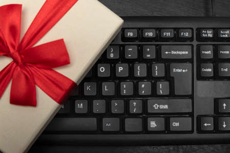 Gift box on computer keyboard. Buying gifts onlineの写真素材