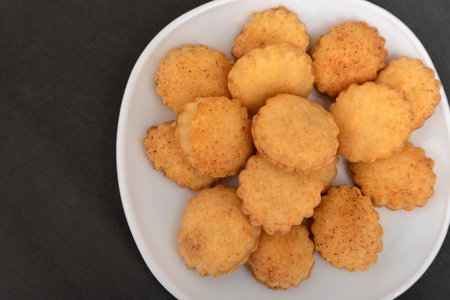 Close up homemade shortcrust pastry cookies on white plat. Gray background. Baking for tea.の写真素材