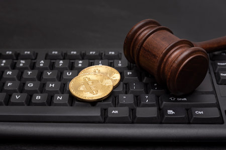 Coin bitcoin with judge hammer on keyboard. Litigation, Online Cryptocurrency Fraud.