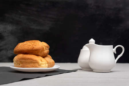 Homemade eclairs and creamer. Traditional French eclairs. Gray background.の写真素材