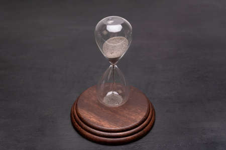 Urgency and outcome of time. Hourglass on stand. Time management concept