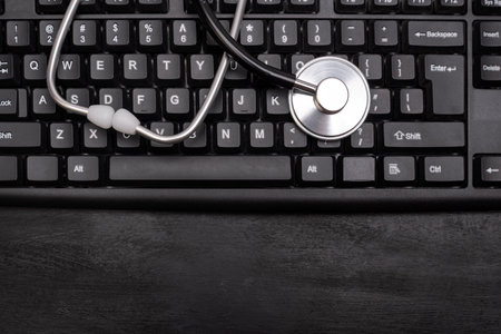 Stethoscope on the computer keyboard. Online consultation with a doctor. Online treatment.の写真素材