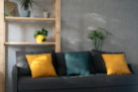 Living room with sofa and colorful pillows out of focus. Interior of an apartment or office receptionの写真素材
