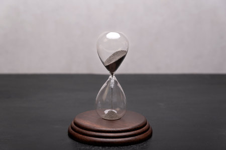 Hourglass on a stand. Time is running out. Time management concept.