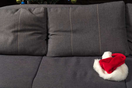 Santa hat on sofa. New Years Eve is over concept.の写真素材