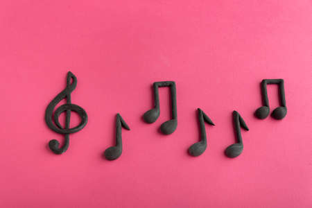 Treble clef and music notes on pink background. Music symbol. Key of G. Violin key. Musical notationの写真素材