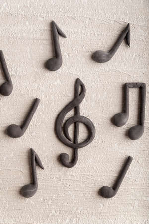 Treble clef and musical notes on beige background. Violin key. CLose up. Top viewの写真素材