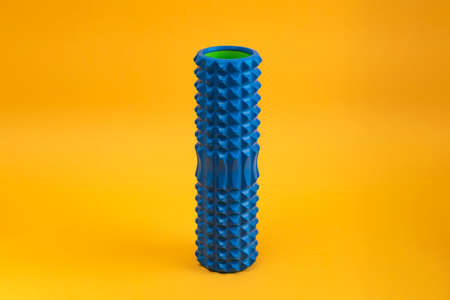 Tools for self-massage on yellow background. Foam roller for myofascial release. Massage rollerの写真素材