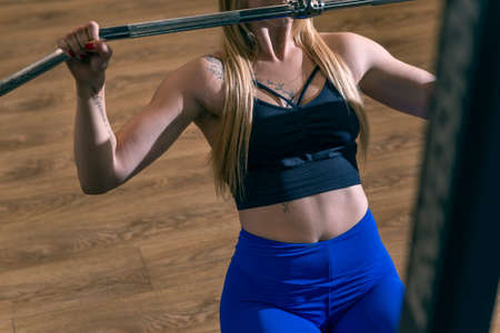 Sporty woman doing thrust of upper block to chest. Girl doing workout exercise with thrust of...