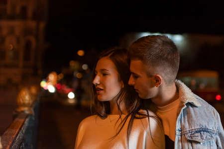 Beautiful young couple stands on the street at night. romantic dateの写真素材