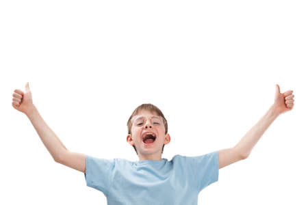 Cheerful teenage boy with glasses raised his hands and points thumbs up. Portrait of funny child isolated on white backgroundの写真素材