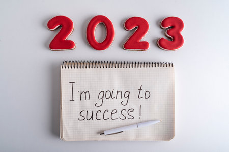 Numbers 2021 and notebook with the words I am going to success. Motivation for 2023
