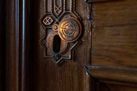 Old keyhole close up. Retro vintage wooden door with brass copper keyholeの写真素材