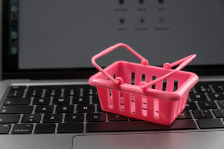 Pink shopping cart on laptop keyboard. online shopping. Shopping on the Internet. online storeの写真素材