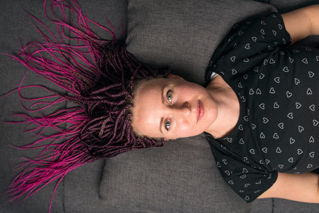 Portrait of woman with pink dreadlocks and t-short with heart pattern. Informal young womanの写真素材