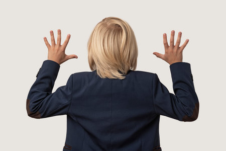 Back view of businessman with arms outstretched looking at camera isolated on white background.の写真素材