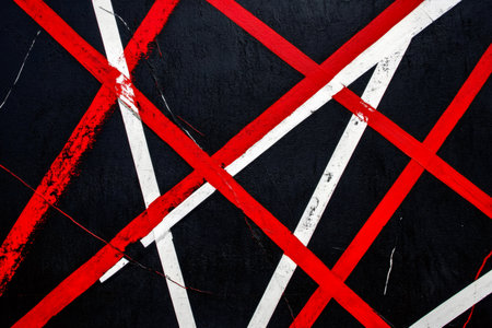Minimalist abstract art featuring intersecting red and white stripes on a black background, creating a dynamic and visually striking compositionの素材