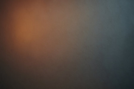 Warm ambient light gradient illuminating a textured wall, creating a cozy and inviting atmosphereの素材