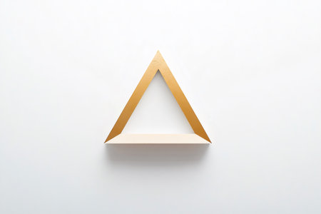 Minimalist artwork featuring a golden triangle frame creating negative space on a white background, ideal for modern and elegant designsの素材