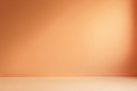 Minimalist soft peach background illuminating an empty room with light from a window, creating a serene and inviting atmosphereの素材
