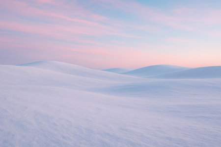 Soft snow covering rolling hills under a beautiful pastel colored sky at dawn, creating a serene winter landscapeの素材