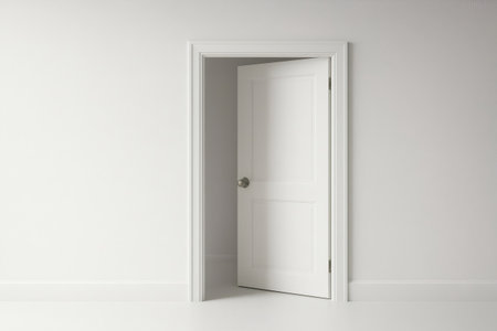 Slightly open white door in a white room, creating a sense of mystery and anticipation for what lies beyondの素材
