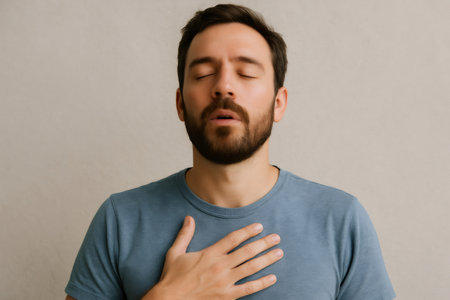 Caucasian man practicing breathing exercises, holding hand on chest, promoting mindfulness and stress reductionの素材