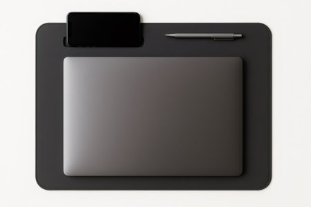 Desk mat essentials including laptop, smartphone and pen, perfect for a modern and organized workspaceの素材