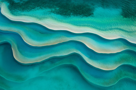 Aerial view of captivating turquoise waves gently flowing over white sandbanks, creating a mesmerizing pattern in a tropical paradiseの素材