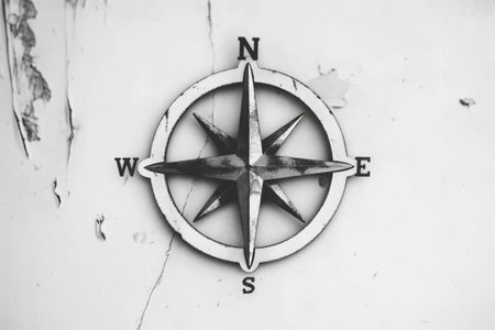 Monochrome photo of a simple compass rose symbol, embodying the spirit of exploration and navigationの素材