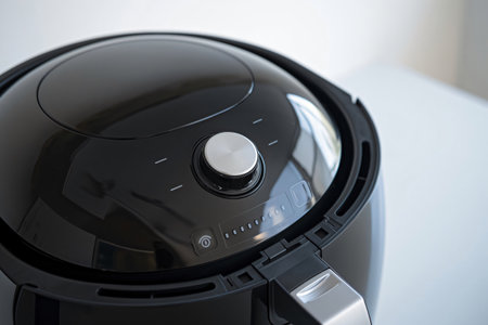 Sleek, modern black air fryer with a clean design and a control panel displaying various cooking settingsの素材